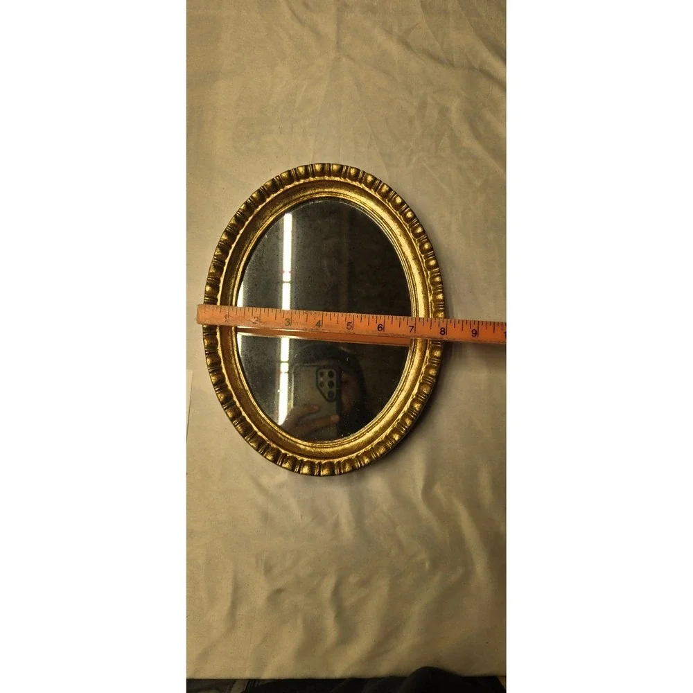 Vintage Or Antique Oval Wall Mirror with An Ornate Gold Gilt Frame